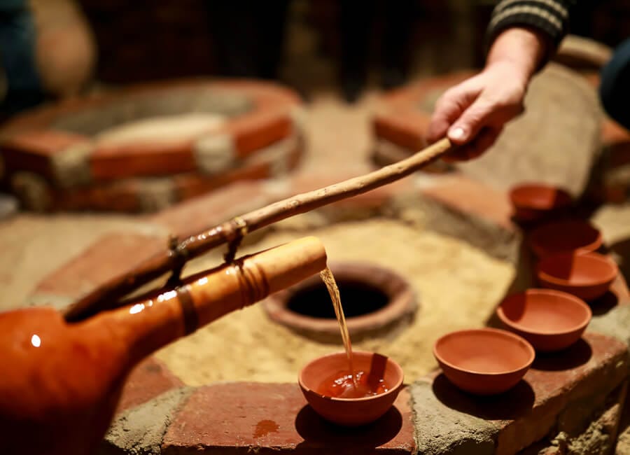 a. general (Pouring wine from qvevri using Orshimo) Georgia DT 174139355